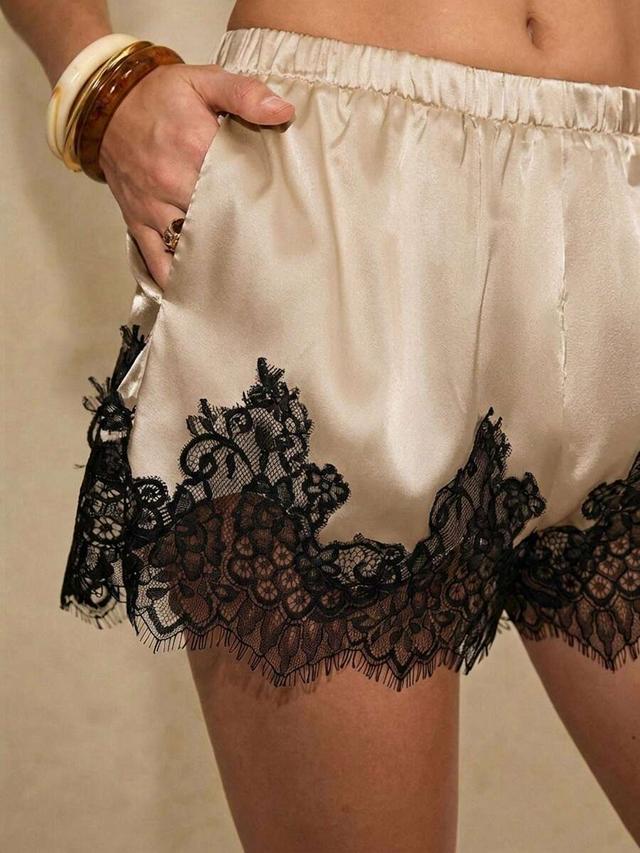 beige satin shorts with black lace trim
