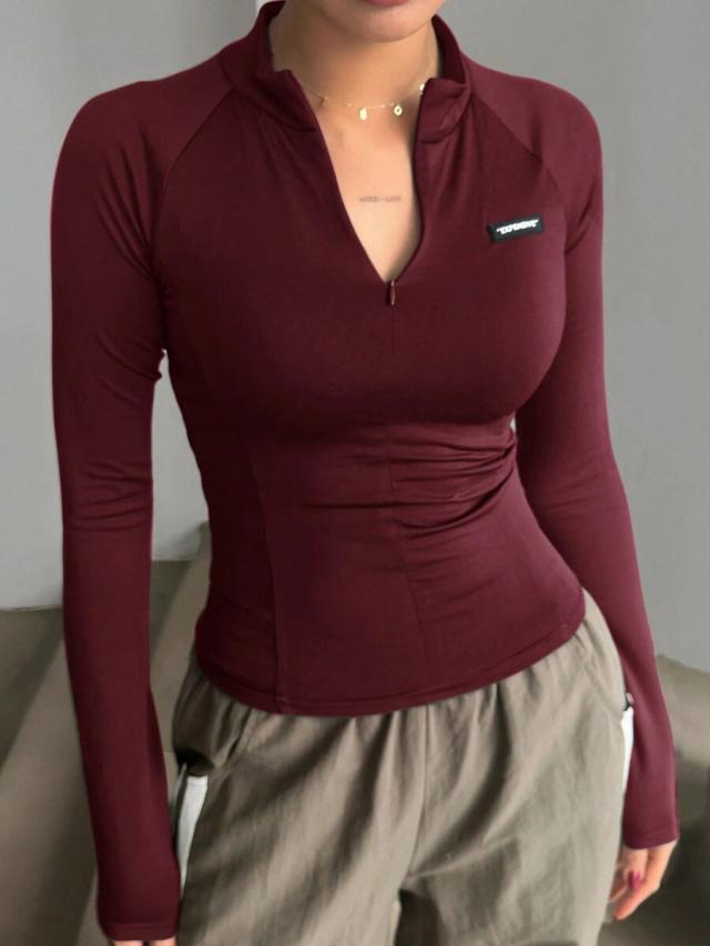 burgundy turtleneck half-zip long sleeve tight fitting top