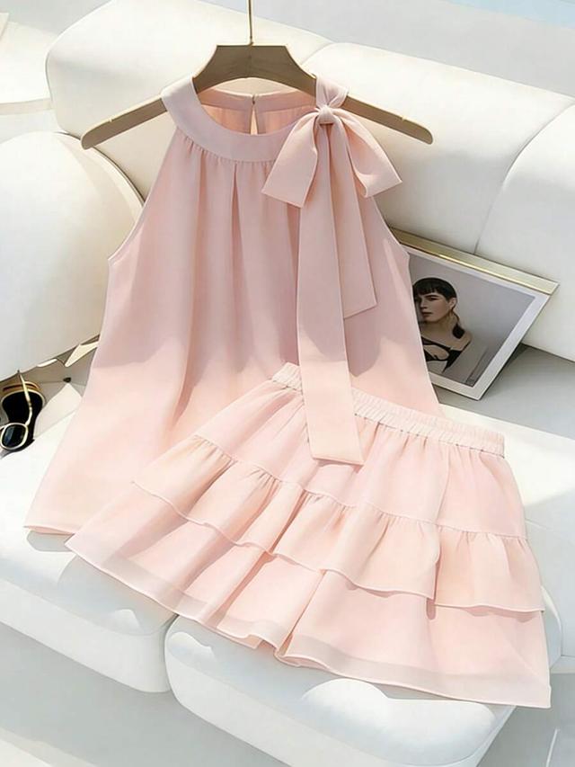 light pink sleeveless tie-front blouse and ruffled skirt set