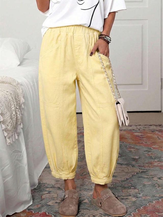 pale yellow elastic waist tapered leg denim jeans