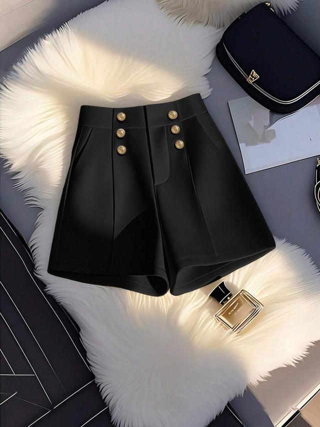 minimalist black a-line shorts with decorative gold buttons