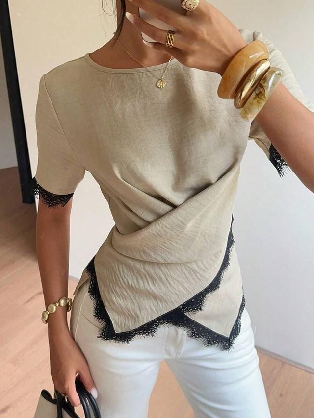 beige linen short-sleeved top with irregular black lace trim