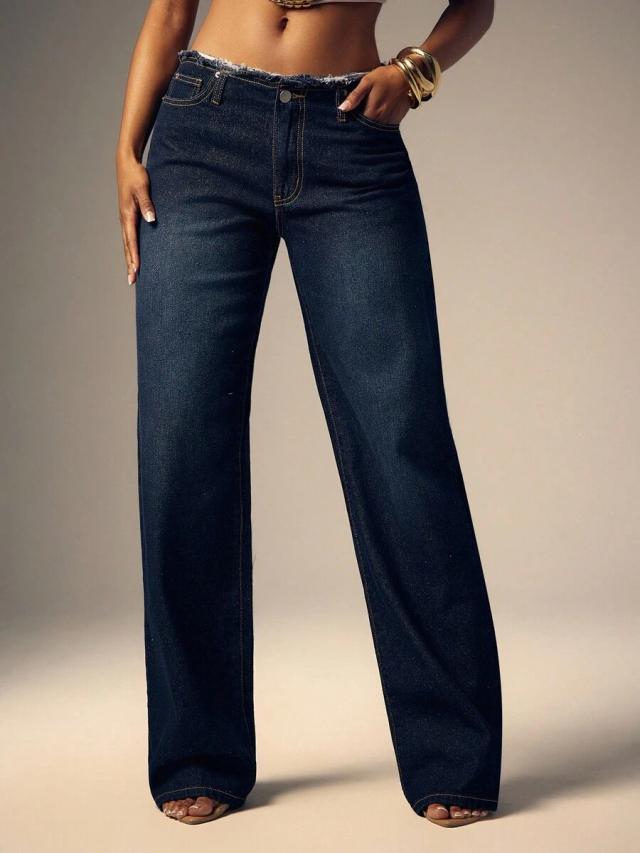 dark wash denim jeans with raw edge waistband