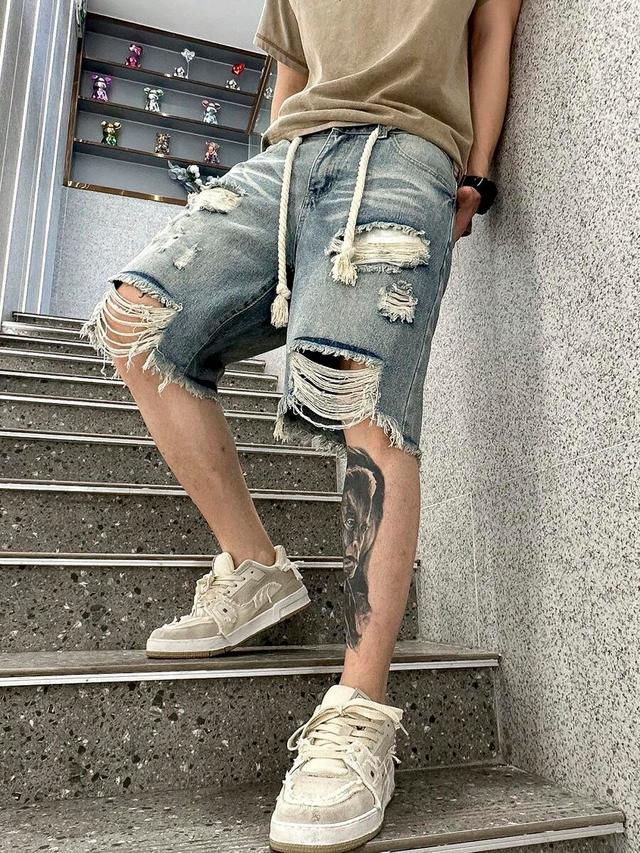 light blue distressed denim jorts with raw frayed hem