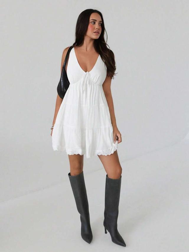 white cotton tiered mini dress with eyelet hem