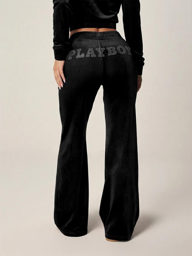 black velour flared sweatpants with rhinestone logo