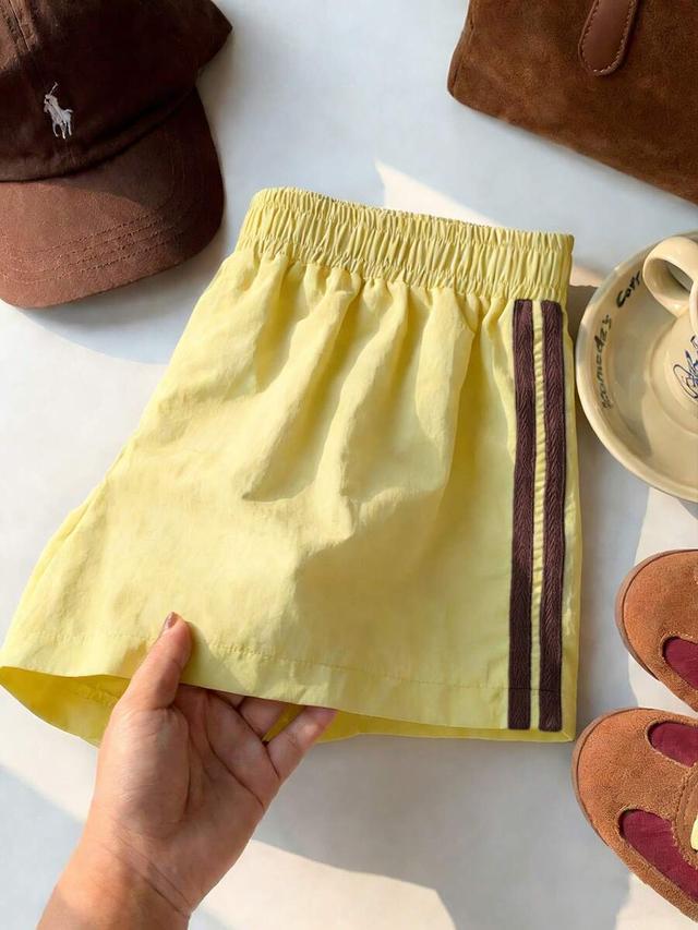yellow elastic waist casual athletic shorts with side stripes