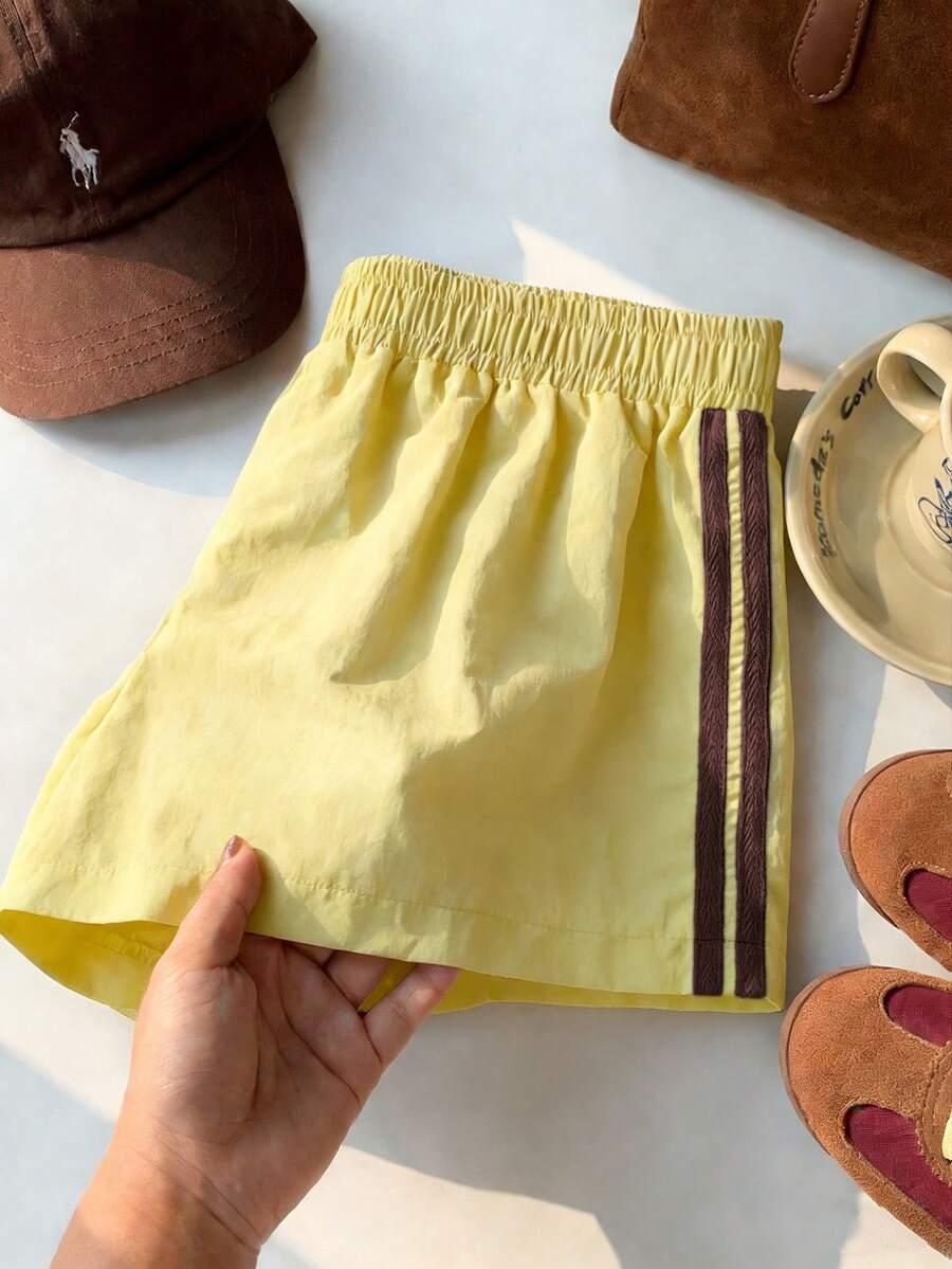 yellow elastic waist casual athletic shorts with side stripes