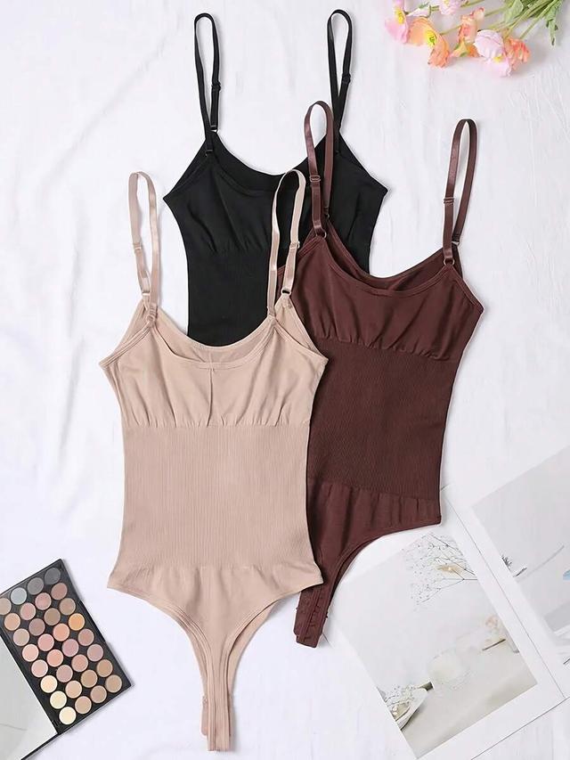 black seamless shaping bodysuit with adjustable straps and tummy control