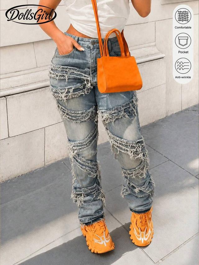 light blue distressed denim jeans with frayed spiral cutouts