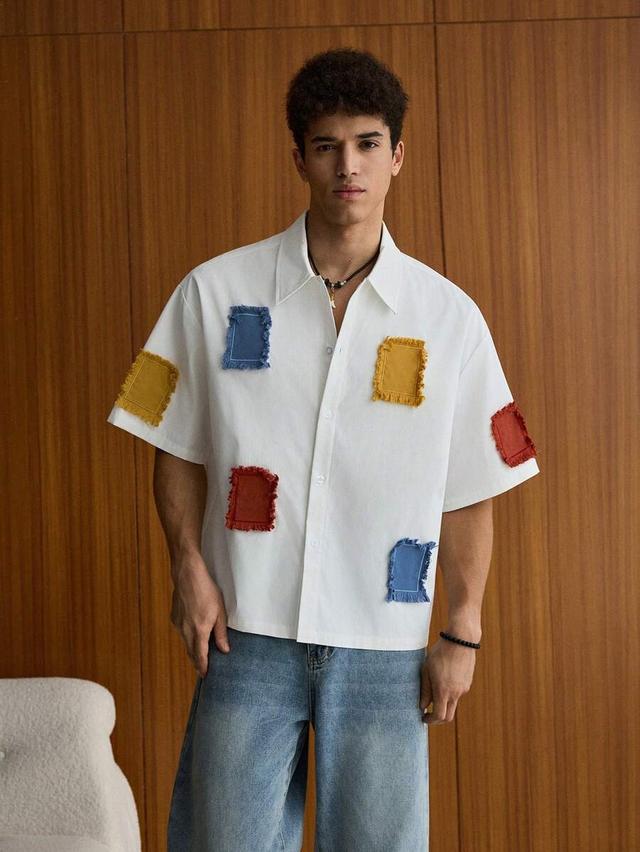 white boxy button up shirt with colorful applique patches
