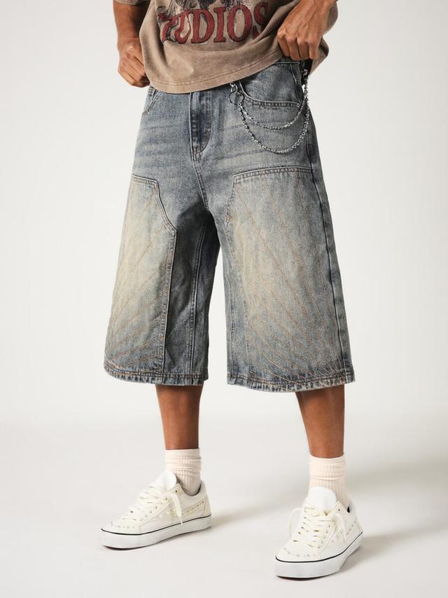 distressed washed denim carpenter jorts with chain detail