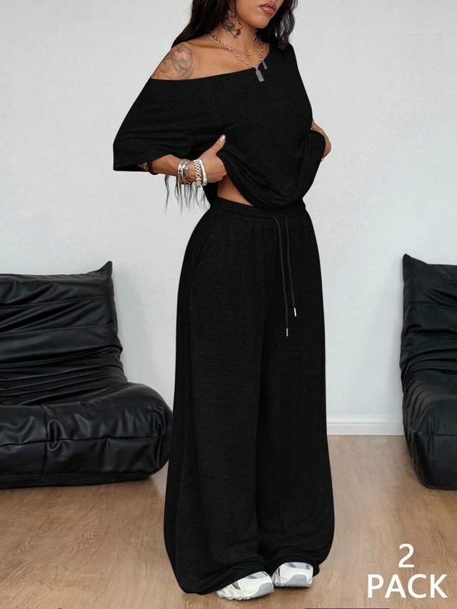 black off-shoulder t-shirt and wide-leg drawstring sweatpants