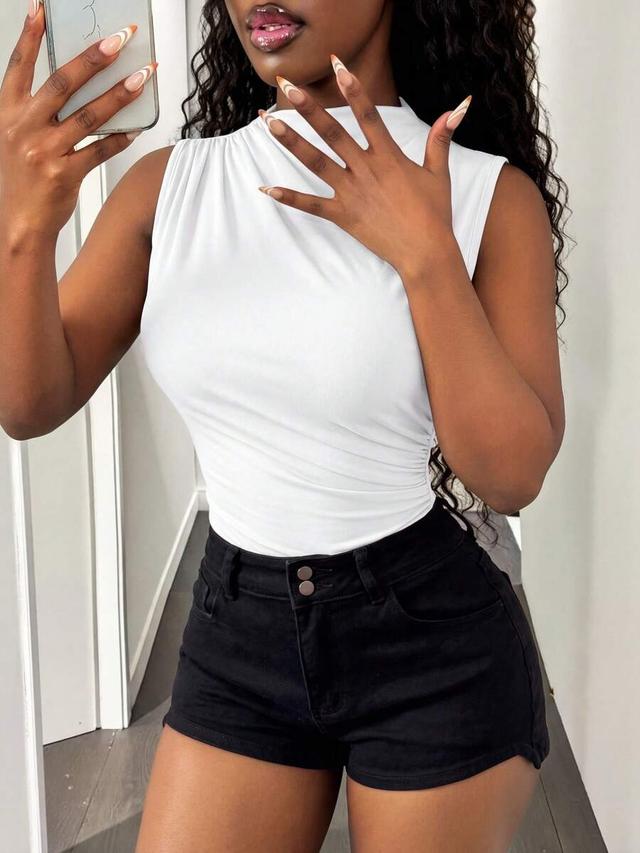white sleeveless bodysuit with stand collar and side pleats