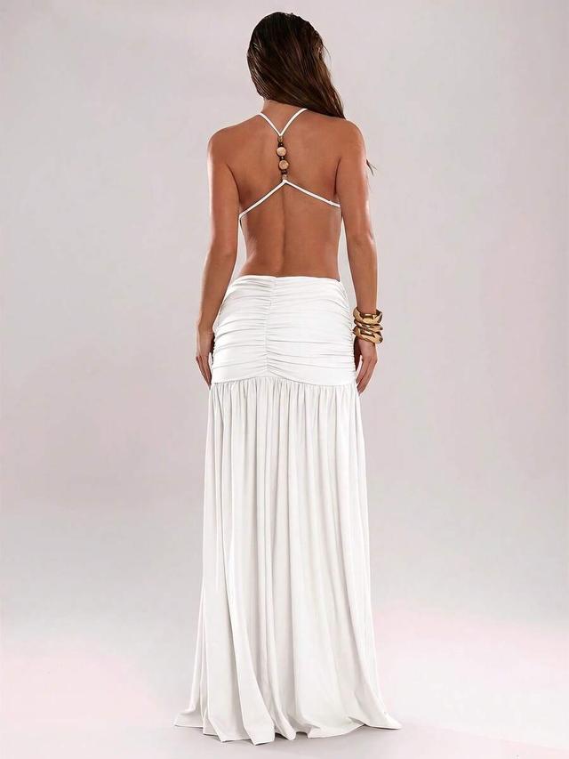 solid white backless halter dress with beaded detail