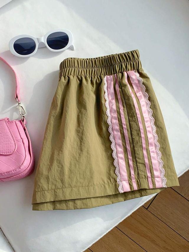 khaki green athletic shorts with pink lace trim