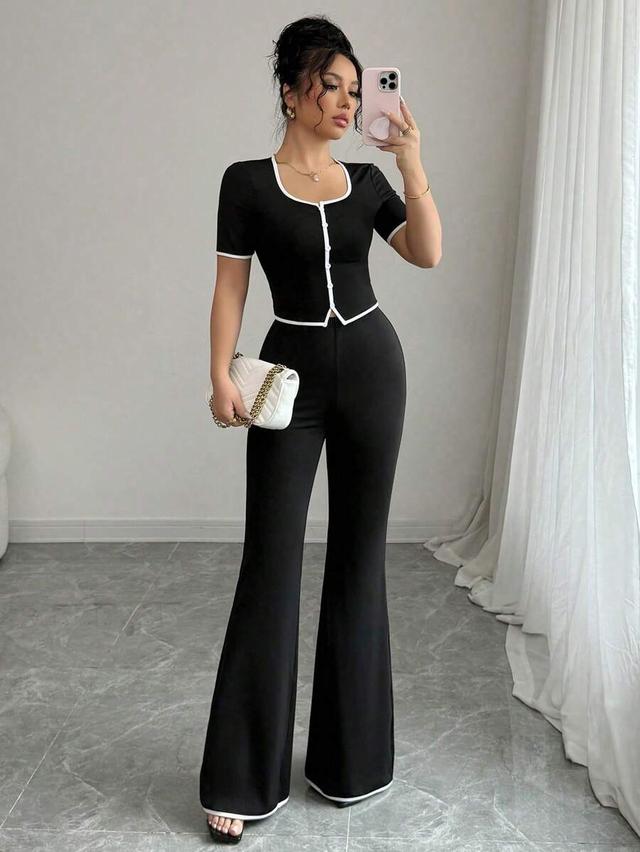 black short sleeve button front top with flared trousers