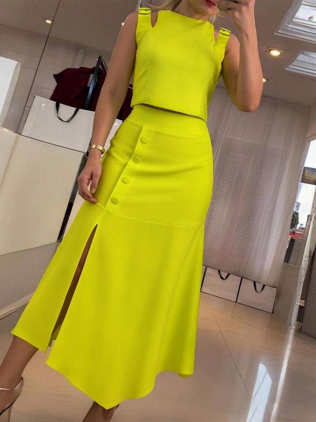 neon yellow sleeveless hollow out top and slit skirt