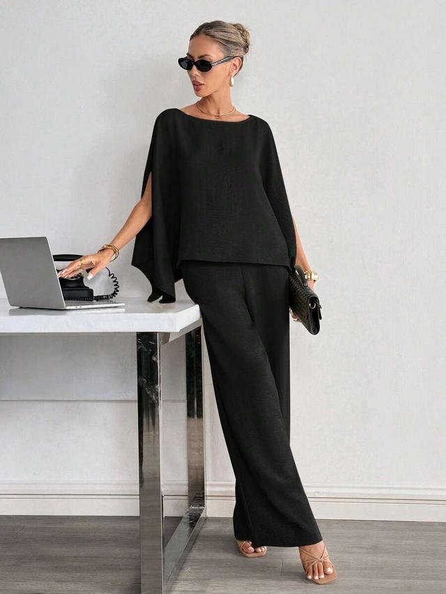 solid black cape sleeve shirt and wide leg trousers