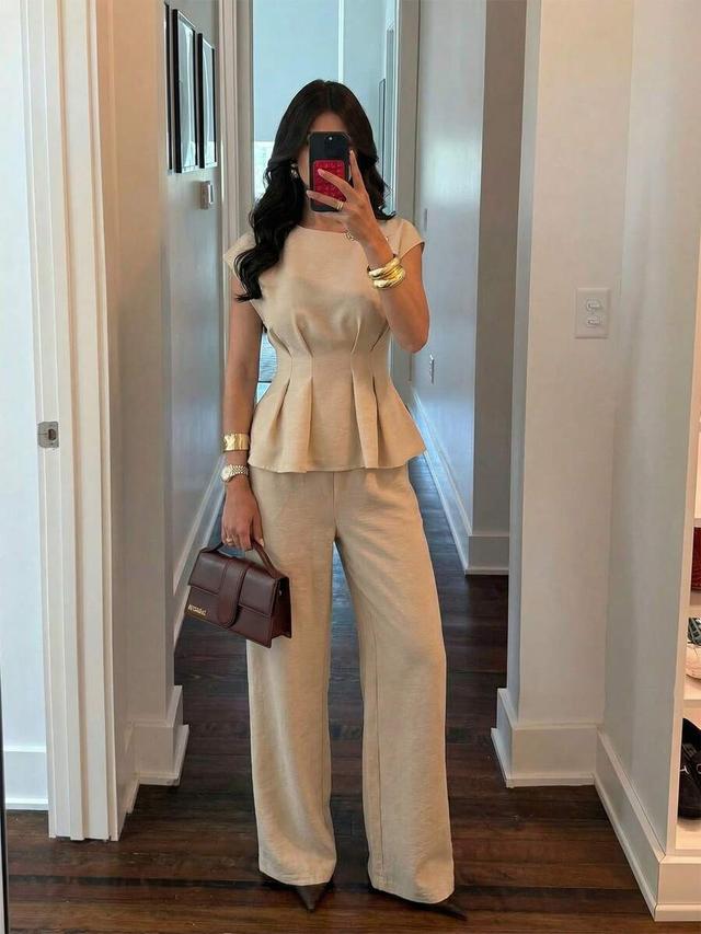 beige asymmetrical shoulder peplum blouse with metal buckle