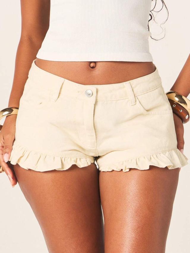 cream low rise denim shorts with ruffle hem