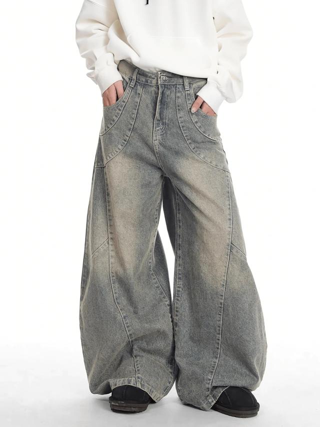 distressed patchwork barrel leg jeans in washed denim