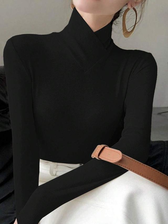 women's solid black knitted cross design stand collar top