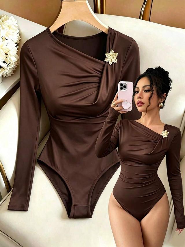 brown long sleeve draped bodysuit with floral brooch
