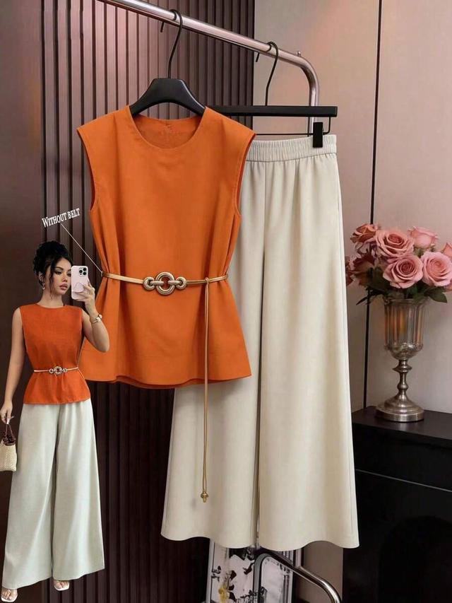 orange sleeveless top and white wide leg pants set