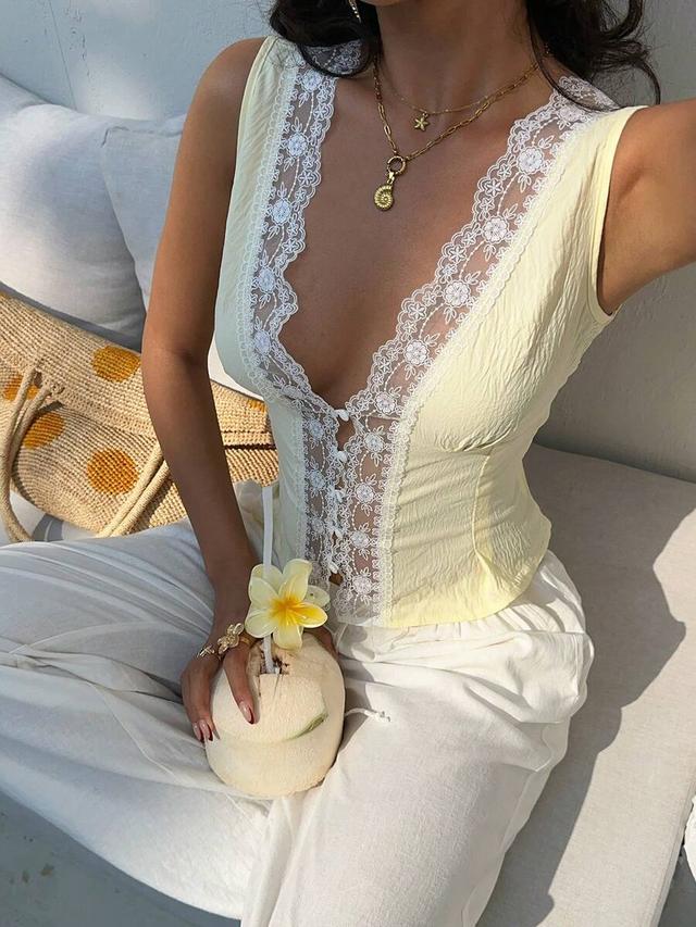 pale yellow sleeveless top with contrast white lace trim