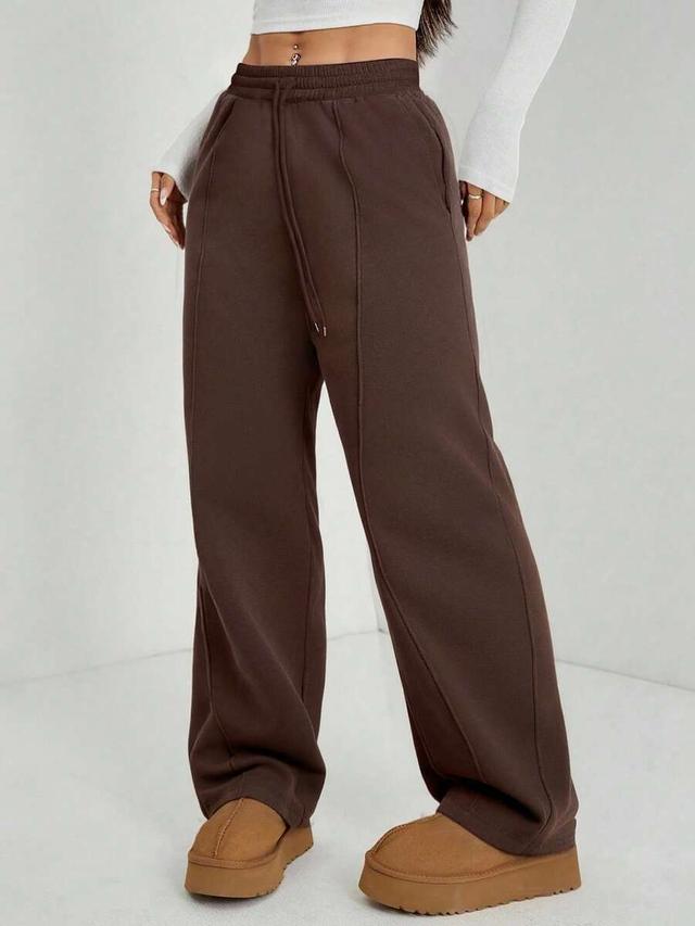 brown straight-leg sweatpants with center seam detail