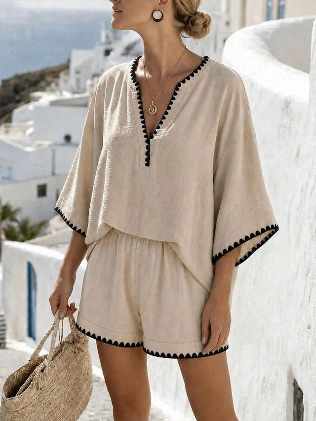 beige linen v-neck batwing top with black embroidery trim and matching shorts
