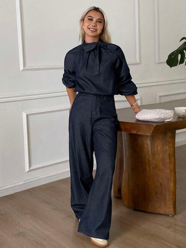 dark wash denim tie-neck blouse and wide-leg trousers