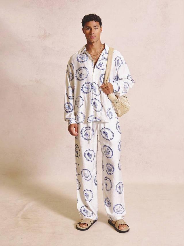 oversized white long sleeve collared shirt with blue motif