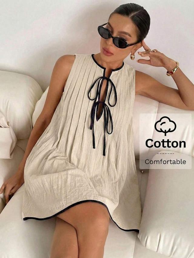cream sleeveless mini dress with black contrast trim