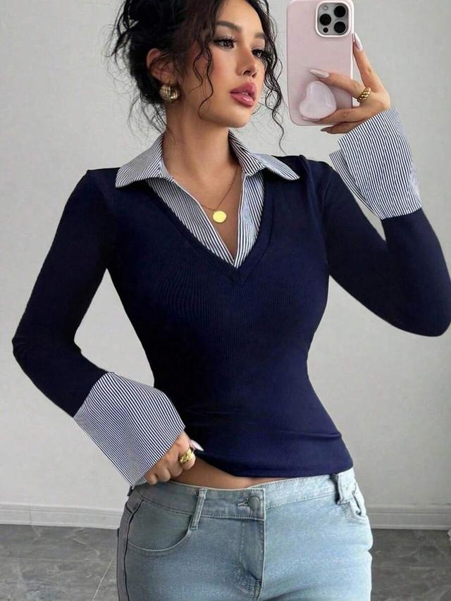 navy blue ribbed v-neck top with striped collar cuffs