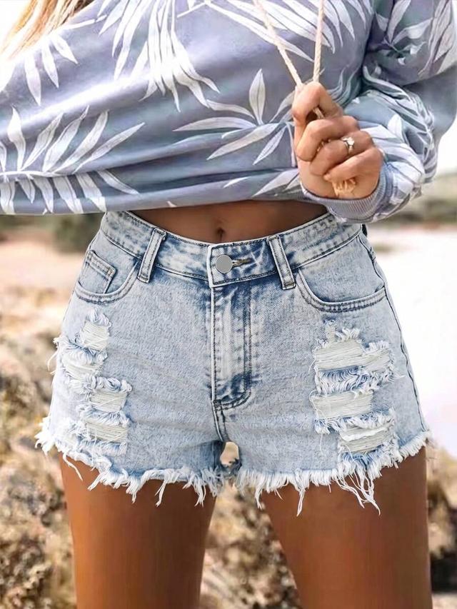 light wash distressed denim shorts with raw hem