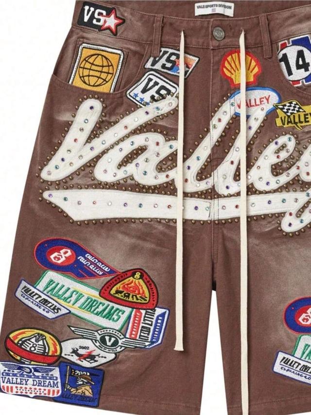 brown denim drawstring shorts with extensive patches and studs
