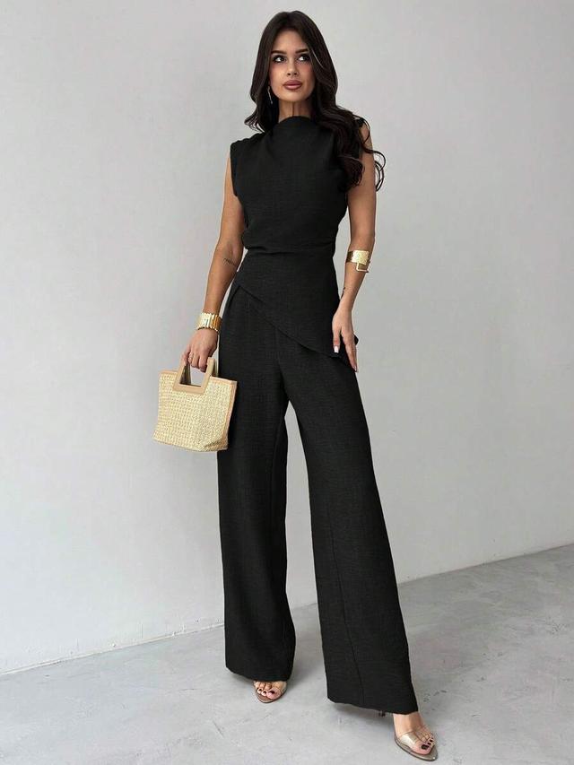 black sleeveless ruched waist blouse and wide leg trousers