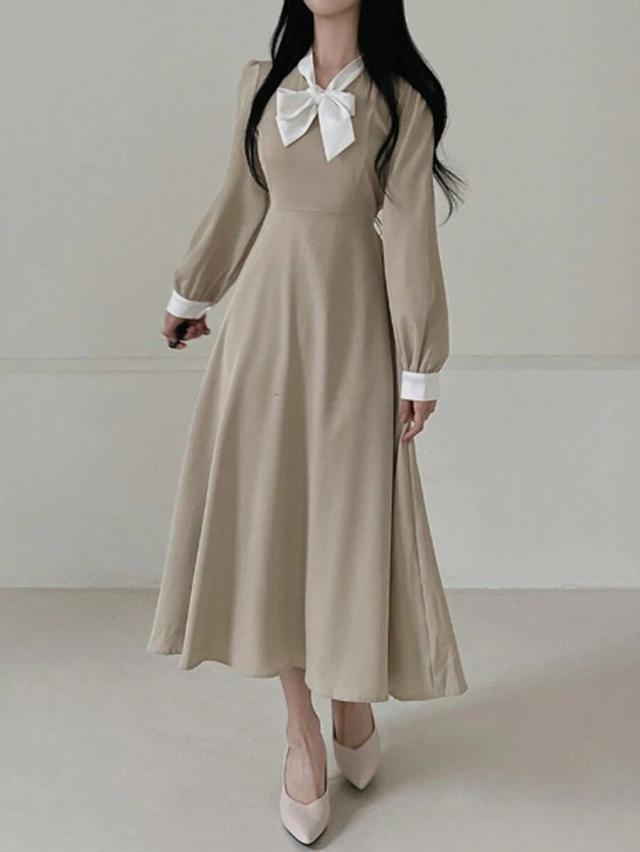 beige long sleeve dress with white tie neck