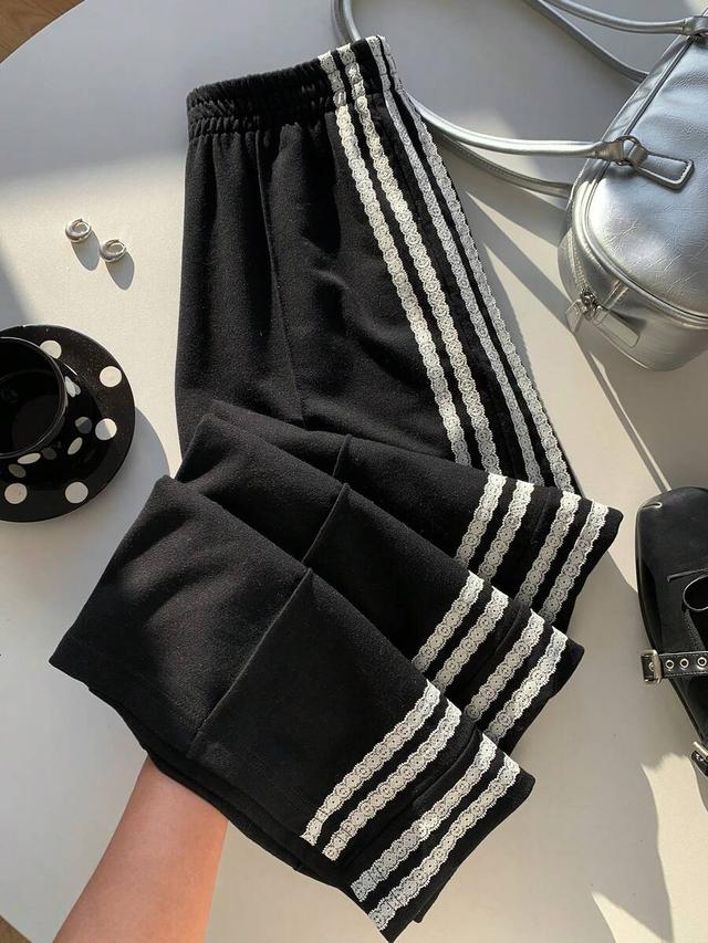 black elastic waist wide leg sweatpants with side stripes