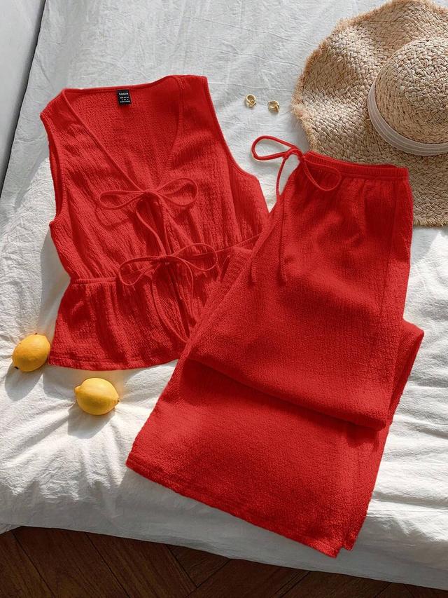 red sleeveless v-neck camisole top with lace-up details