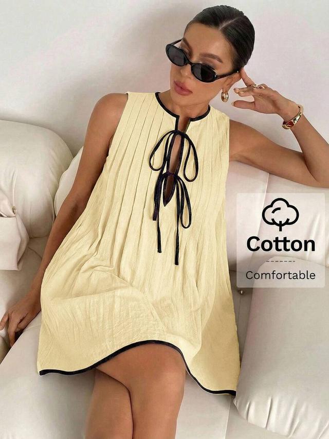 yellow sleeveless pleated mini dress with contrast trim