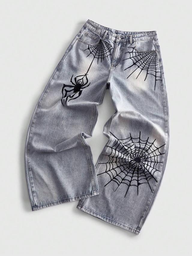 light wash loose fit jeans with spiderweb embroidery
