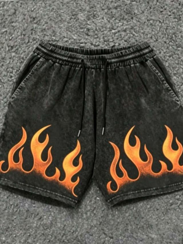 black acid wash denim shorts with pink flame print
