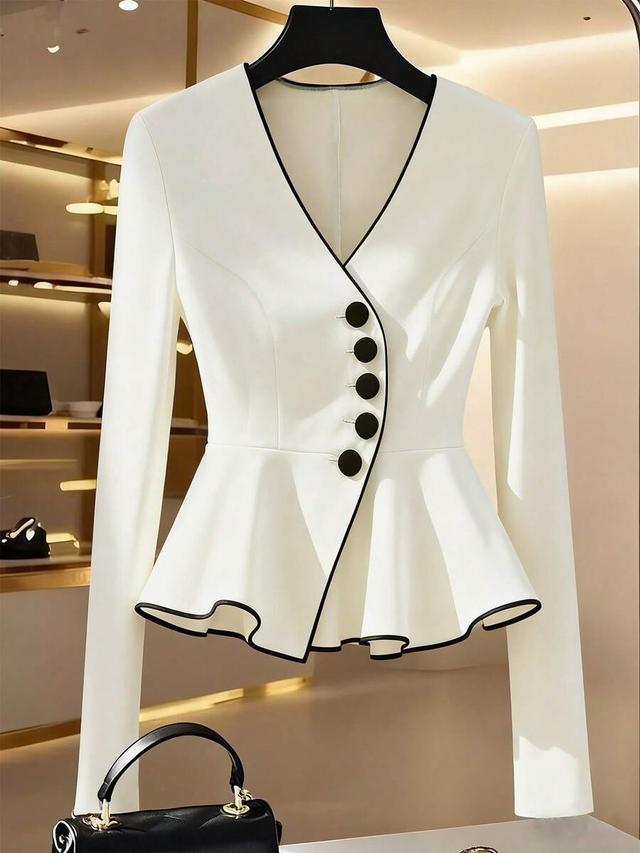 elegant white color-blocked peplum blouse with black trim