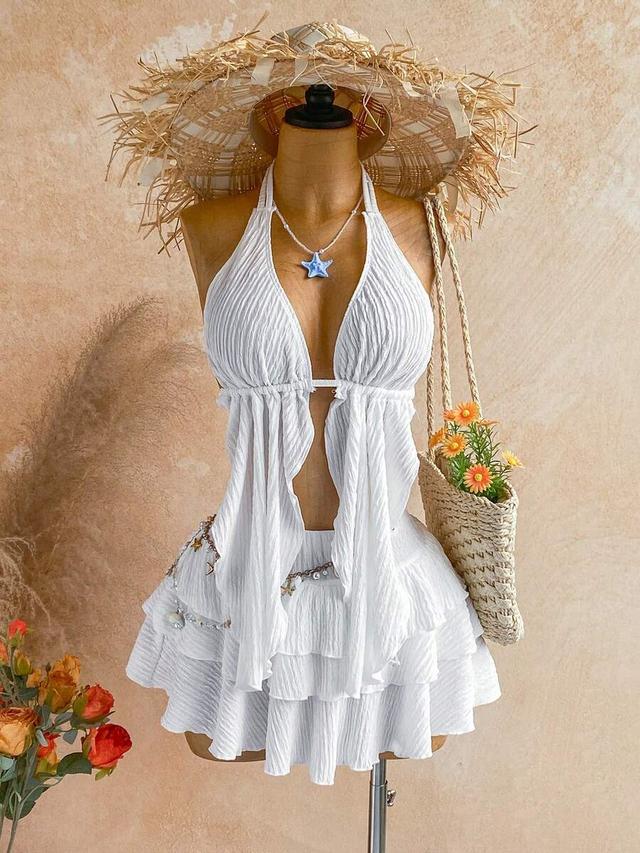 white textured halter neck top and layered ruffle skirt