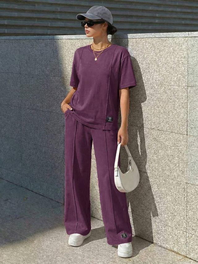 purple crew neck top and matching wide leg trousers