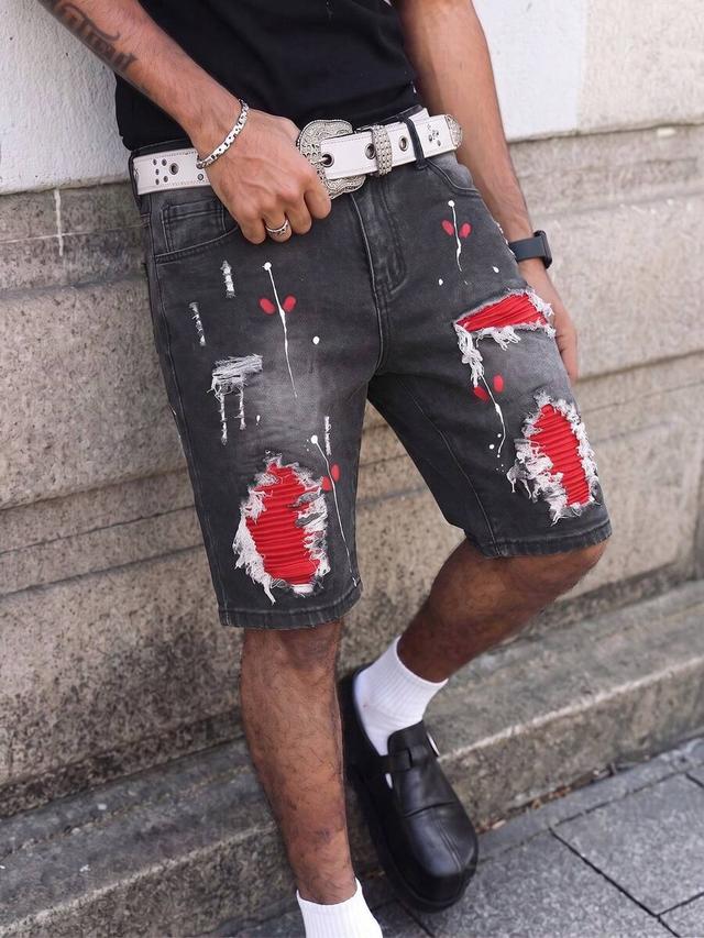 distressed black denim shorts with red patch detailing