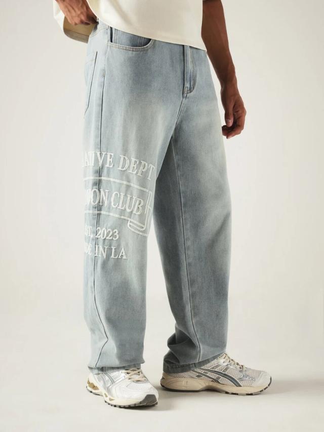 wide leg light wash denim jeans with slogan embroidery